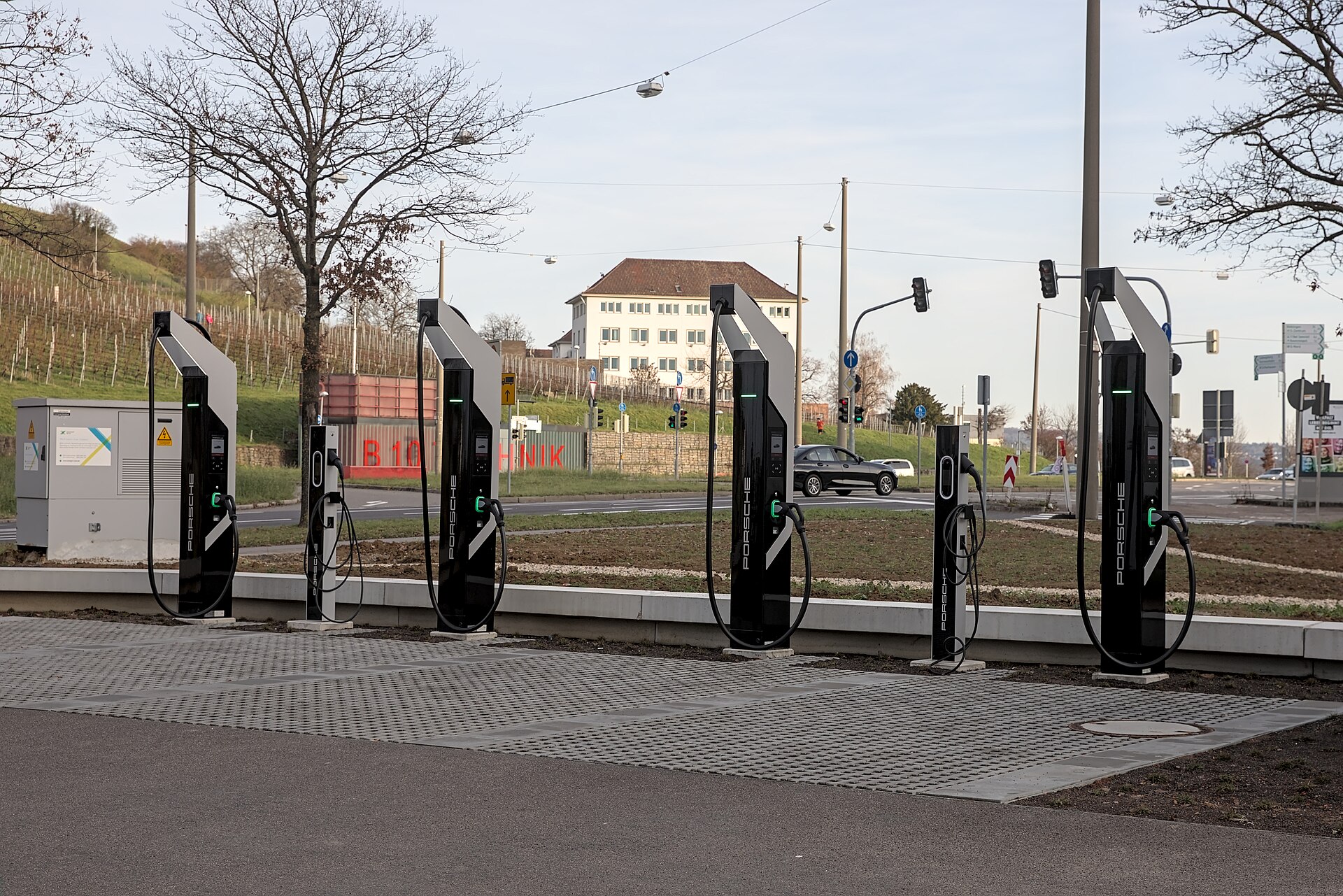 A row of public electric vehicle charging posts on a street in Stuttgart.