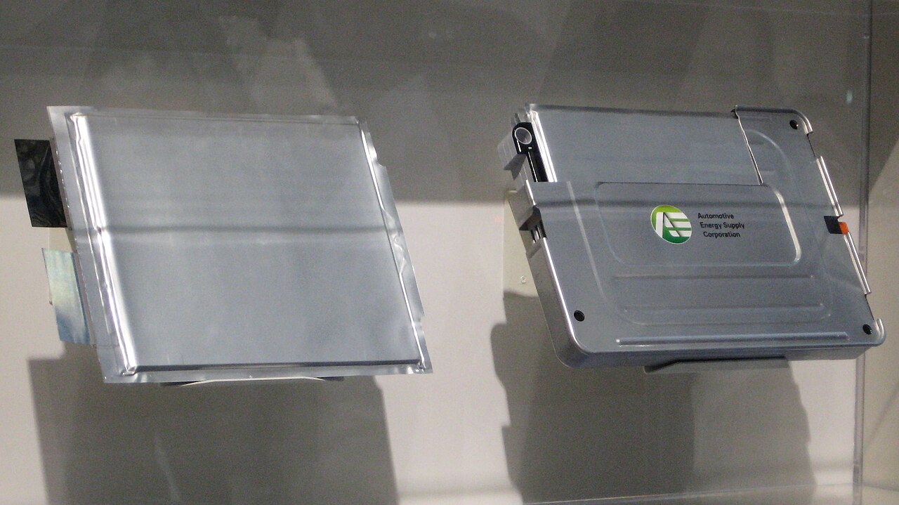 Flat lithium-ion traction battery pack displayed on a stand