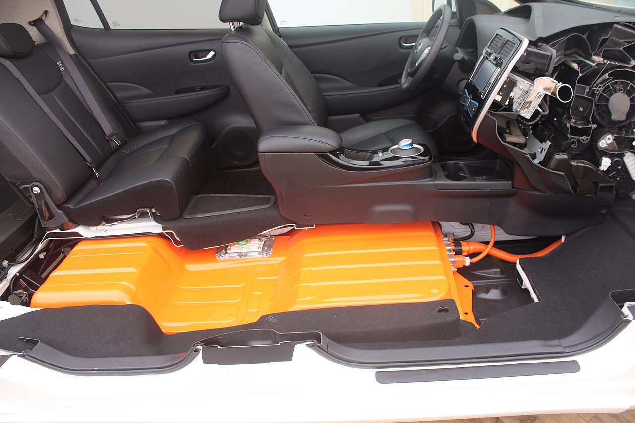 Cutaway electric car showing the battery pack laid out beneath the floor