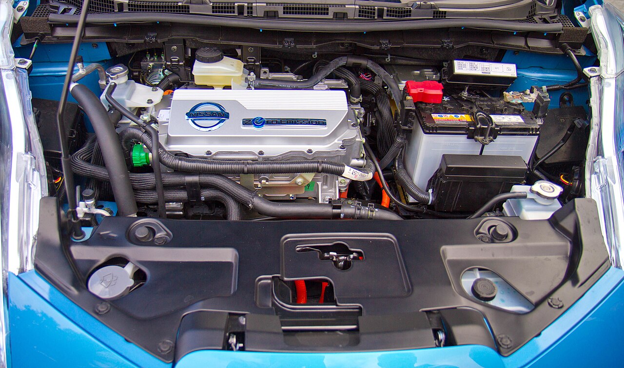 Open front compartment of an electric car showing the motor and power electronics