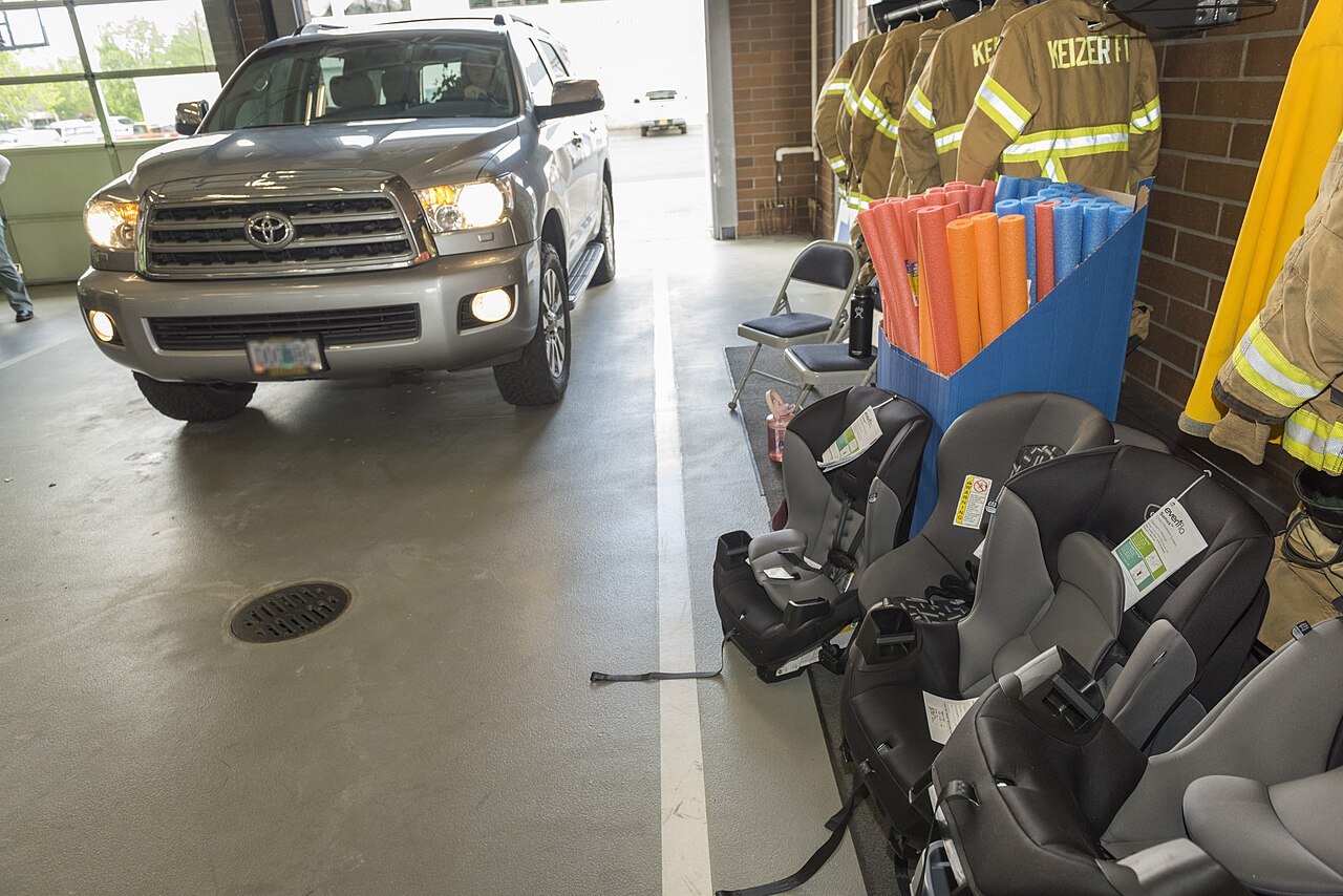 Several unused child car seats lined up ready for fitting checks