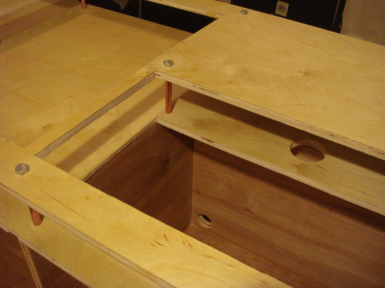 Close view of a mixer recessed into a wooden DJ table cut-out