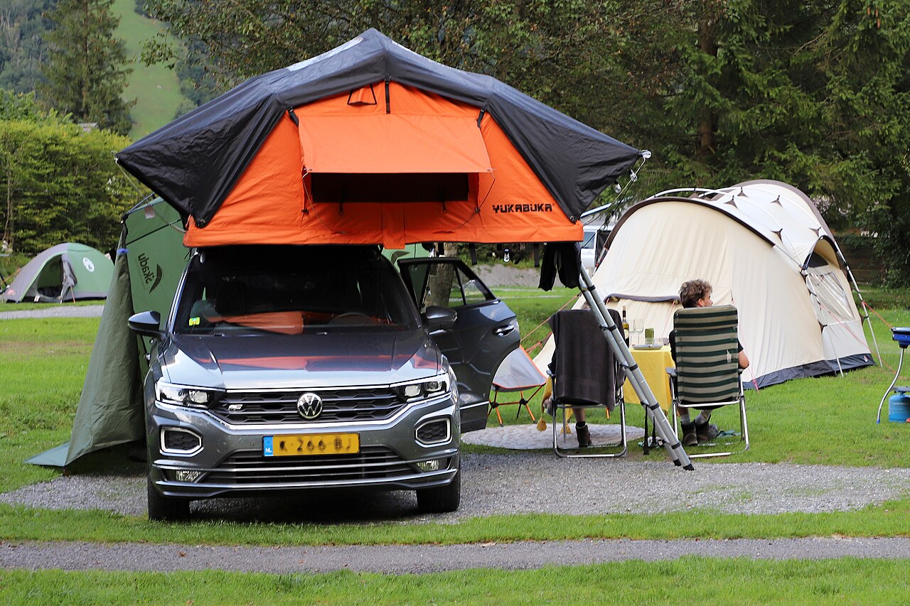 Tent pitched on a roof rack on top of a parked car