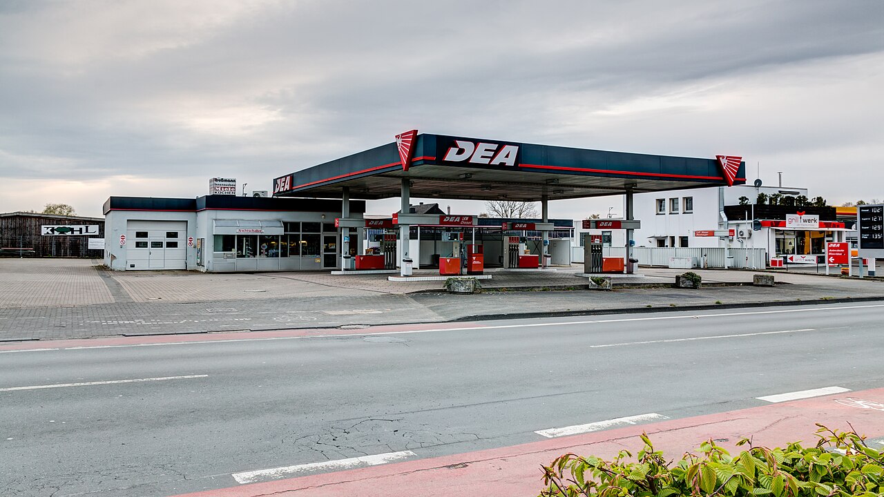 German filling station forecourt with pumps under a wide flat canopy