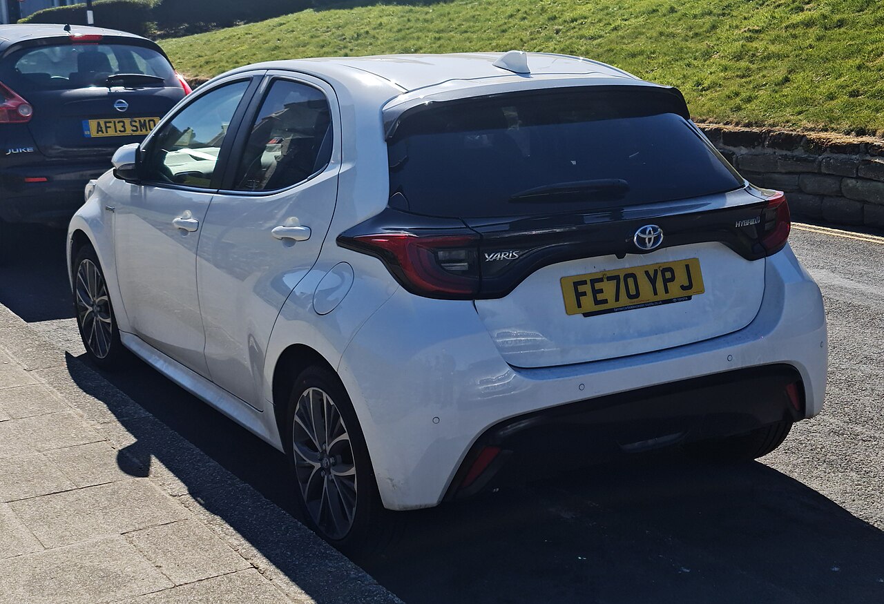 Compact hybrid hatchback photographed outdoors from the front three-quarter angle