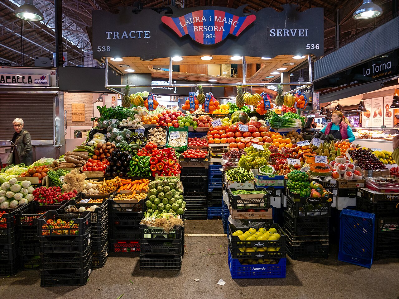 Greengrocer's stall stacked with fruit and vegetables in Barcelona's Boqueria market
