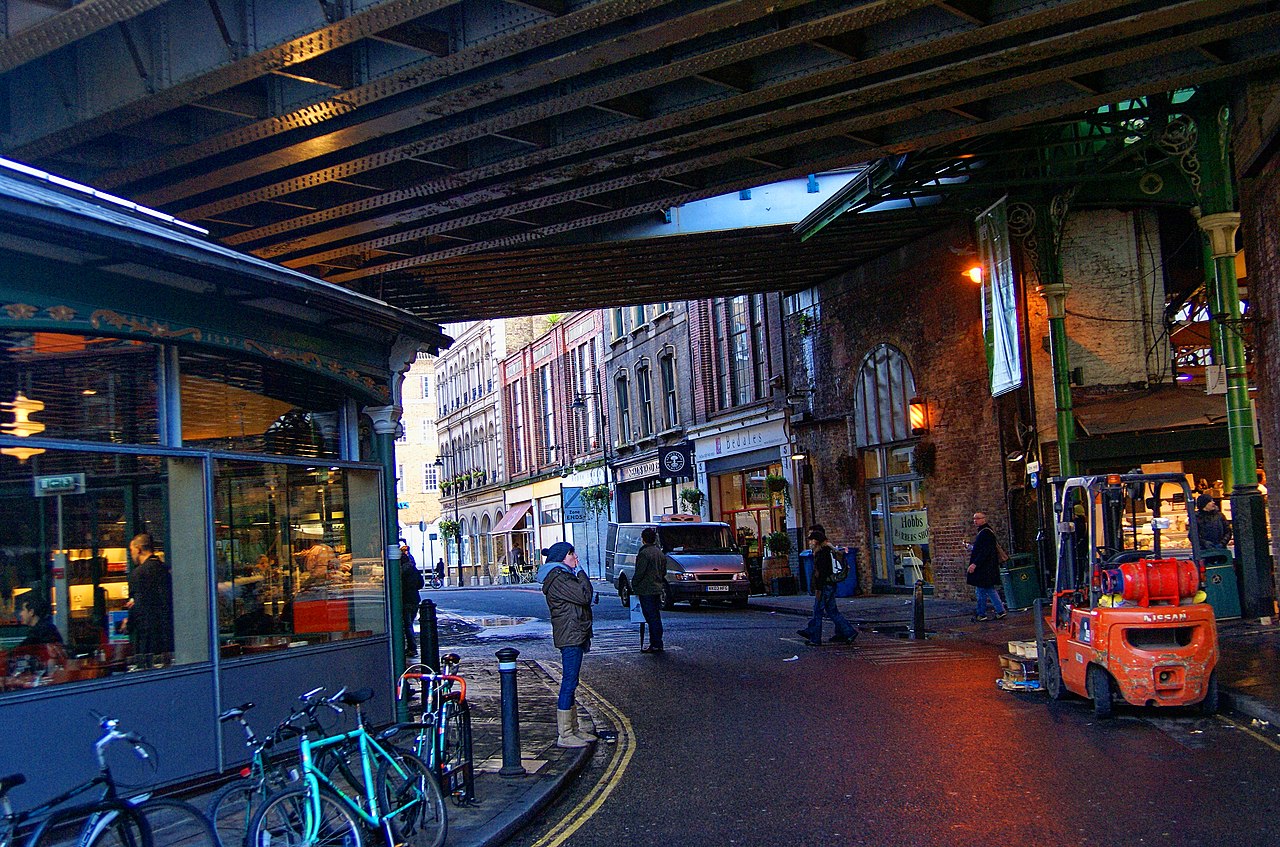 Produce stalls under the iron roof of Borough Market on Bedale Street, London
