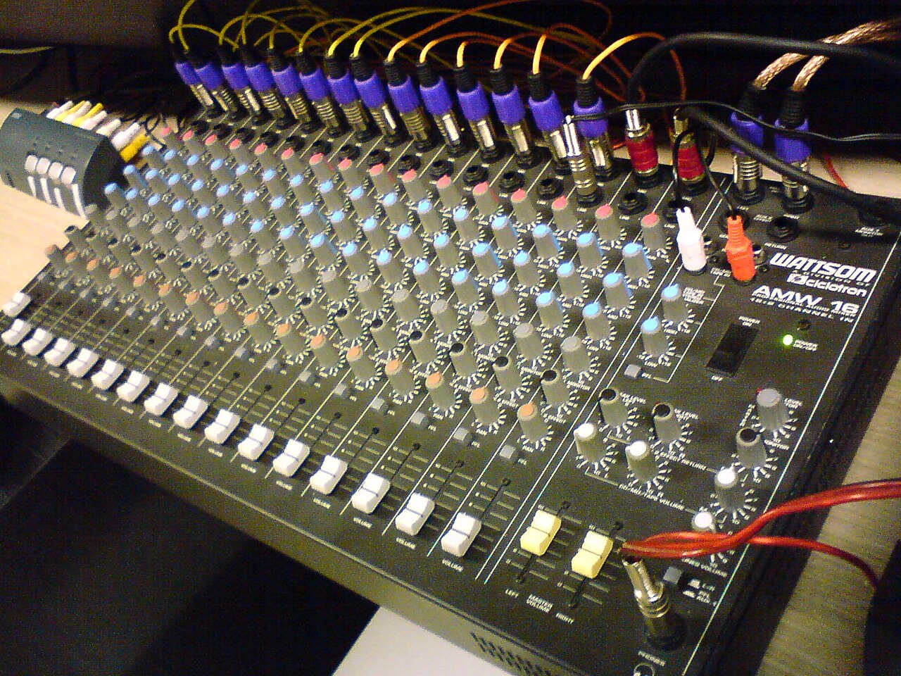 Sixteen-channel analogue mixing console with faders, EQ knobs and routing buttons