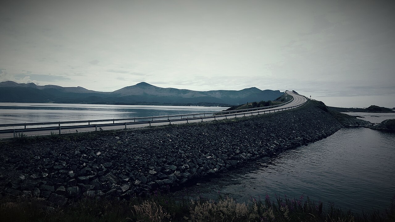 Coastal road hopping between skerries with open sea on both sides