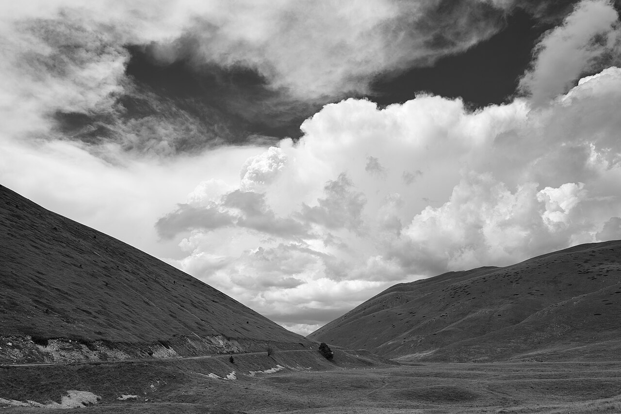 Empty mountain road in the Abruzzo highlands under a wide sky