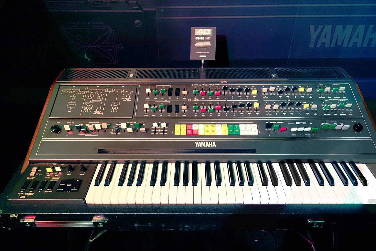 Large vintage polyphonic synthesizer with weighted keyboard and coloured tab controls