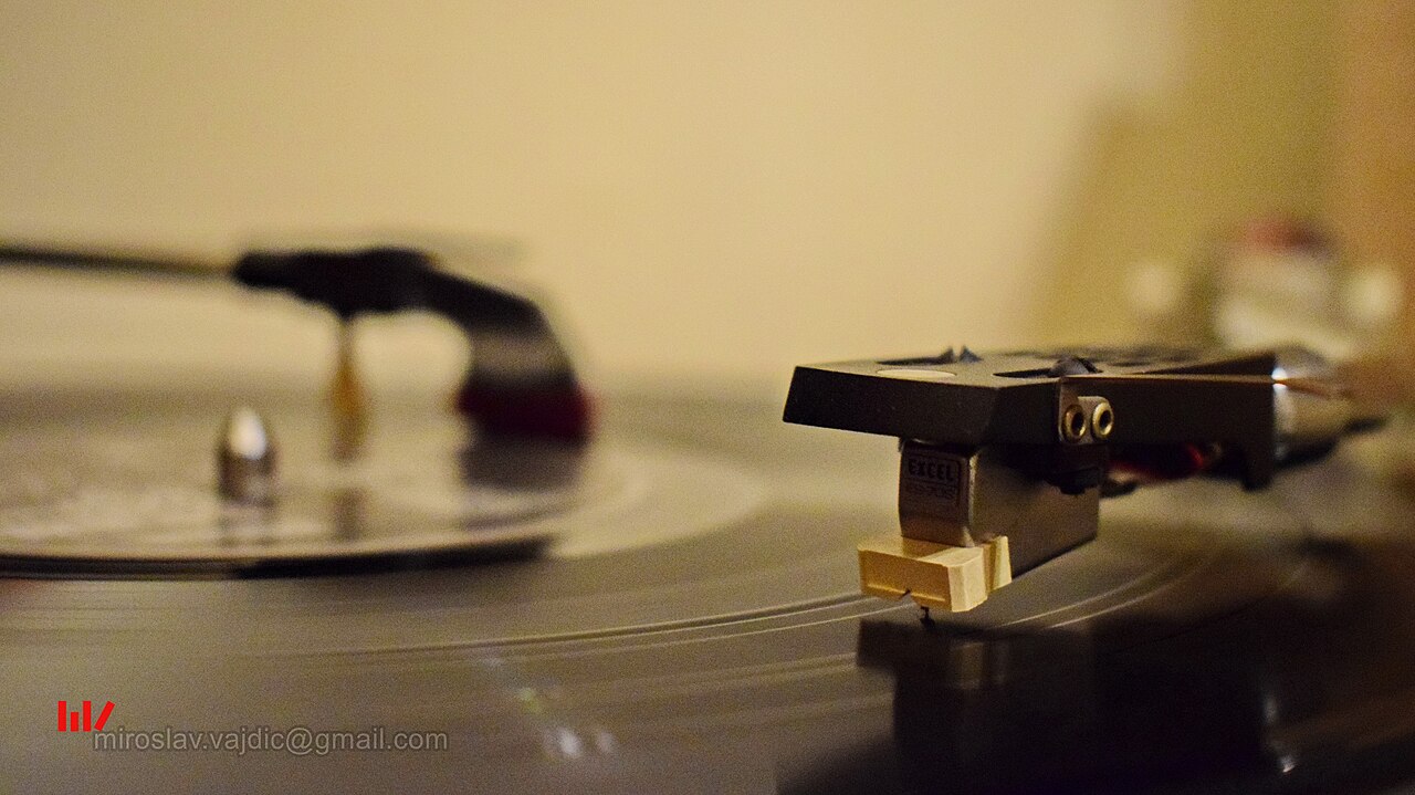 Direct-drive turntable with platter, tonearm and an aftermarket record brush fitted