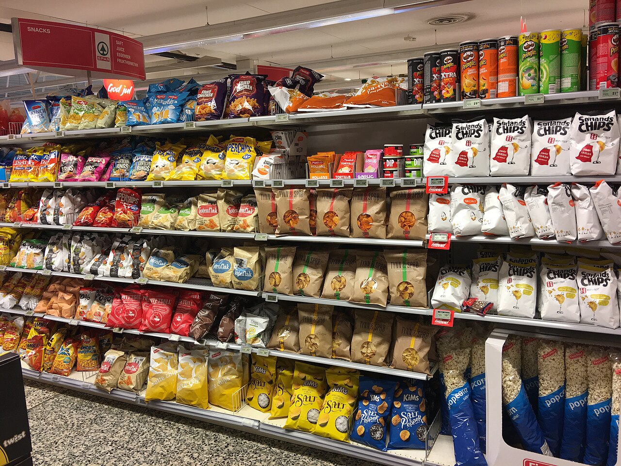 Supermarket aisle stocked with bagged crisps and popcorn in Tjøme, Norway