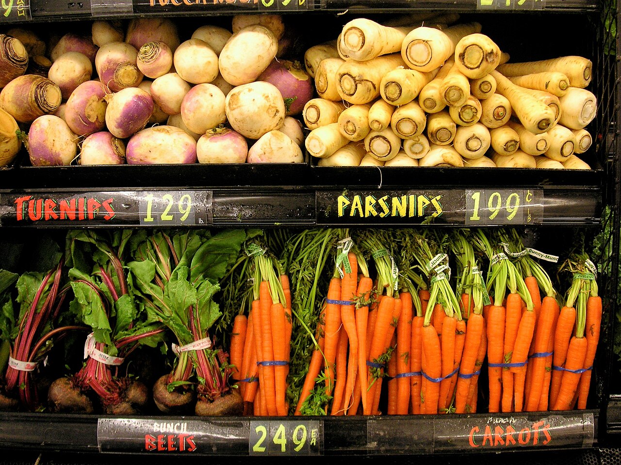 Turnips, parsnips, carrots and beetroot displayed together at a food market