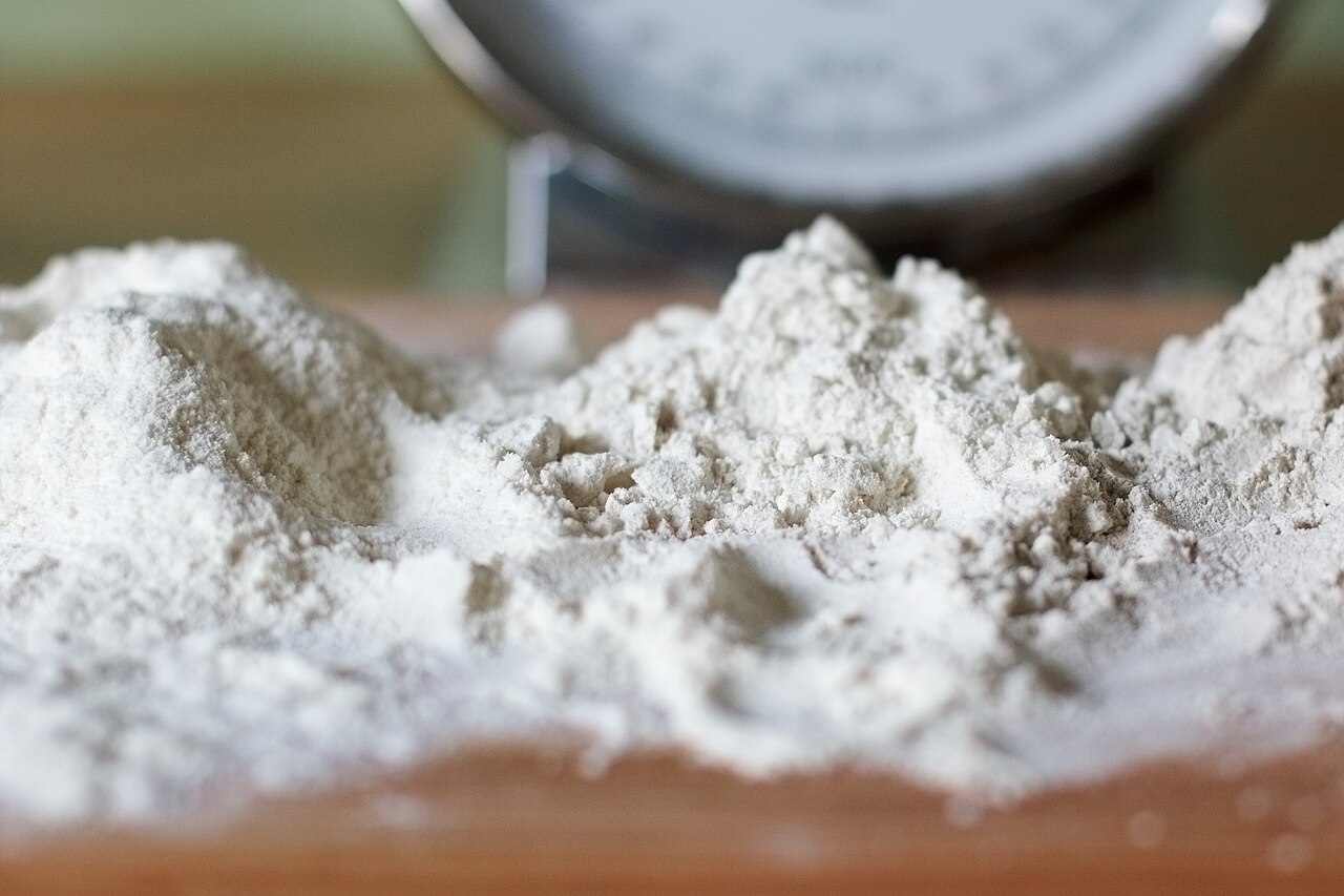 Three heaps of German bread flour: two wheat grades and one rye